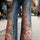 JEANS FLORAL FLARE CINTURA ALTA